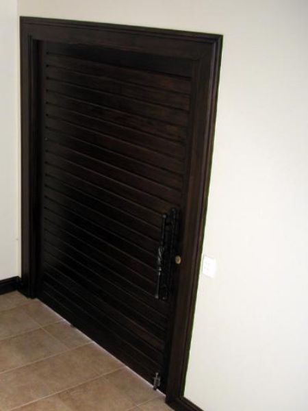Interior home view of the Meranti Horizontal Slatted Pivot Door 