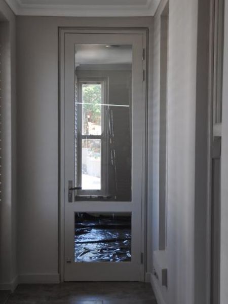 Picture of the Full Pane with Safety Rail 813 mm x 2032 mm Patio Door with hardware and installed in a doorframe, shown closed
